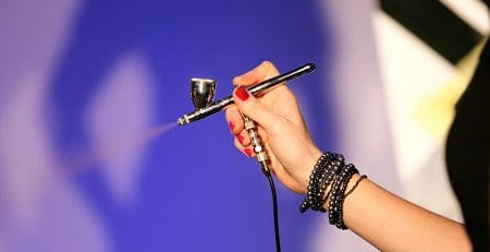 Airbrush in hand of make-up artist