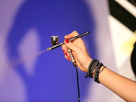 Airbrush in hand of make-up artist